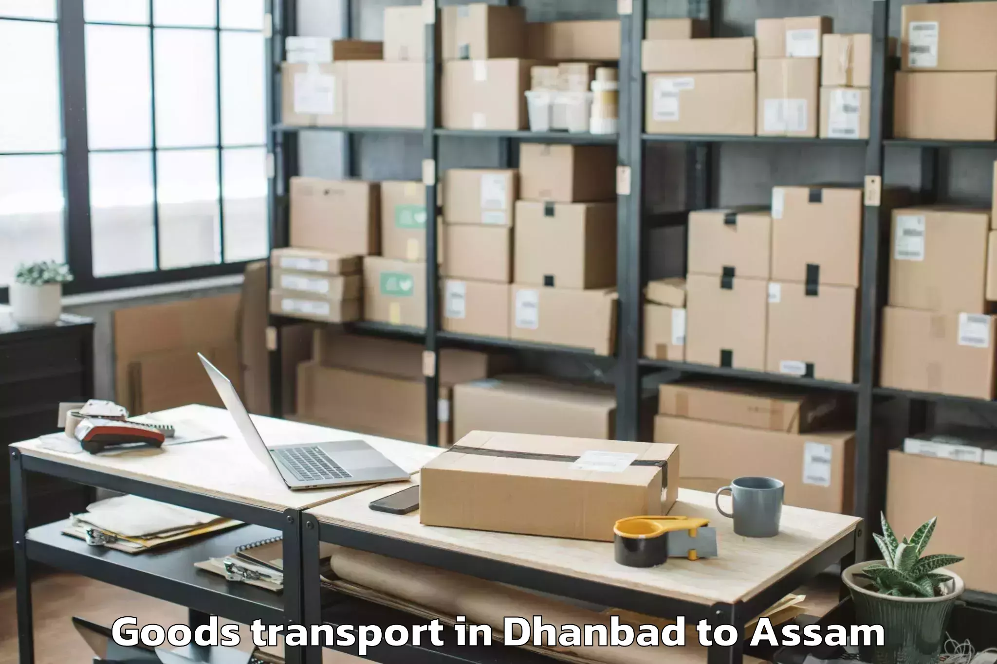 Dhanbad to Marigaon Goods Transport Booking